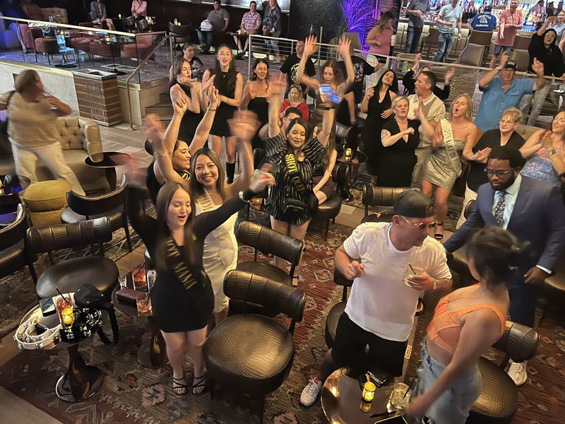 Guests dancing and singing along with hands up